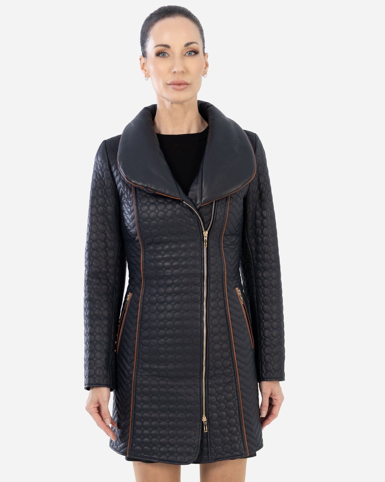 Woman wearing a navy blue quilted trench coat.