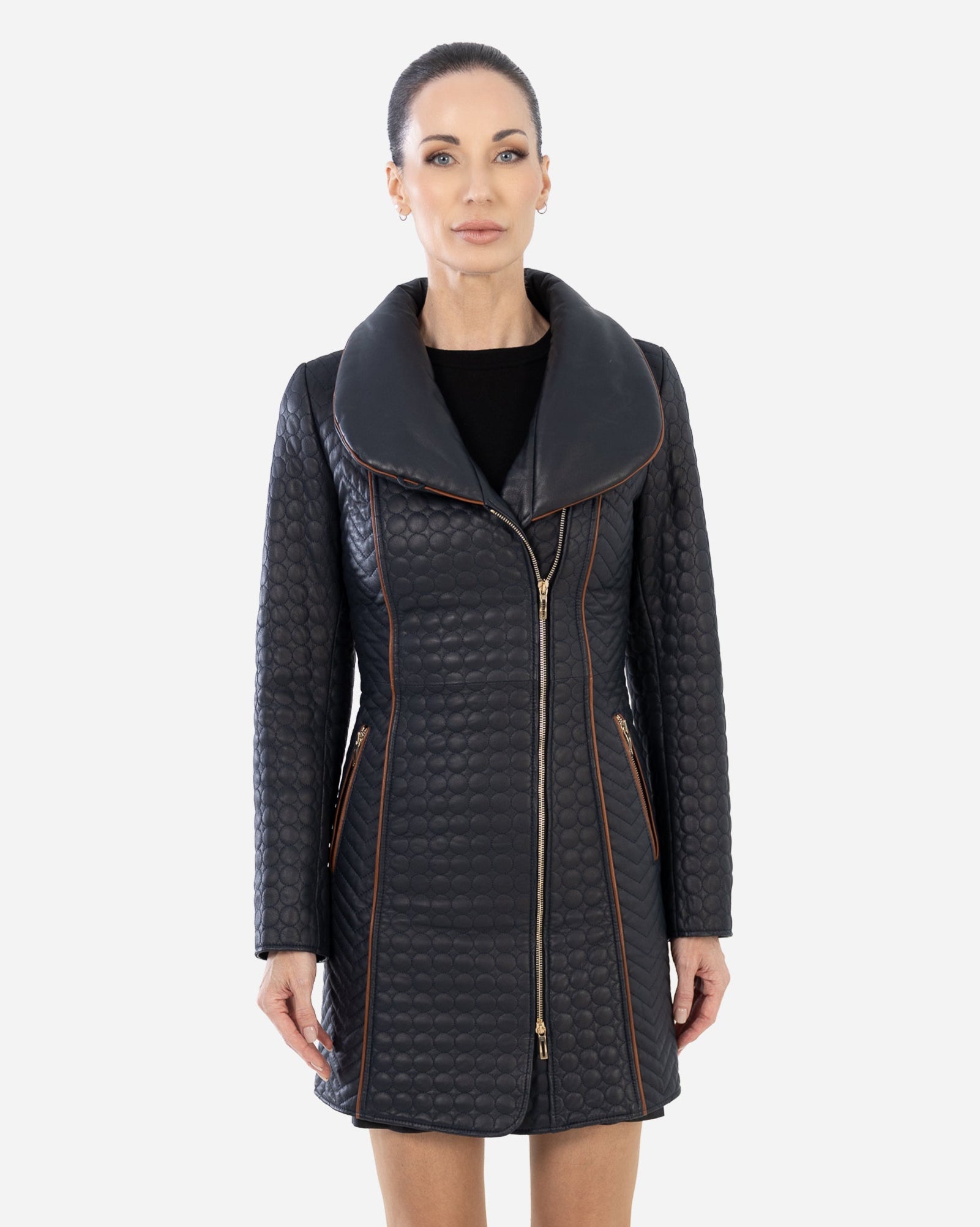 Woman wearing a navy blue quilted trench coat.